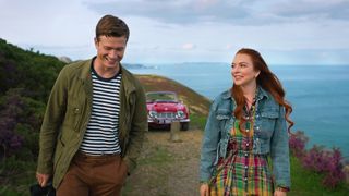 James and Maddie smile as they enjoy a walk on Ireland's coast in Netflix movie Irish Wish