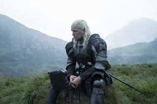 Matt Smith as Daemon Targaryen, wearing armor and sitting on a grassy hill, in 'House of the Dragon' season 2