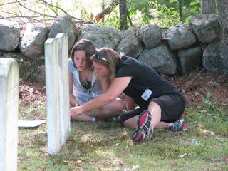 A mom and daughter volunteer team measure the thickness of a gravestone in Casco, Maine.