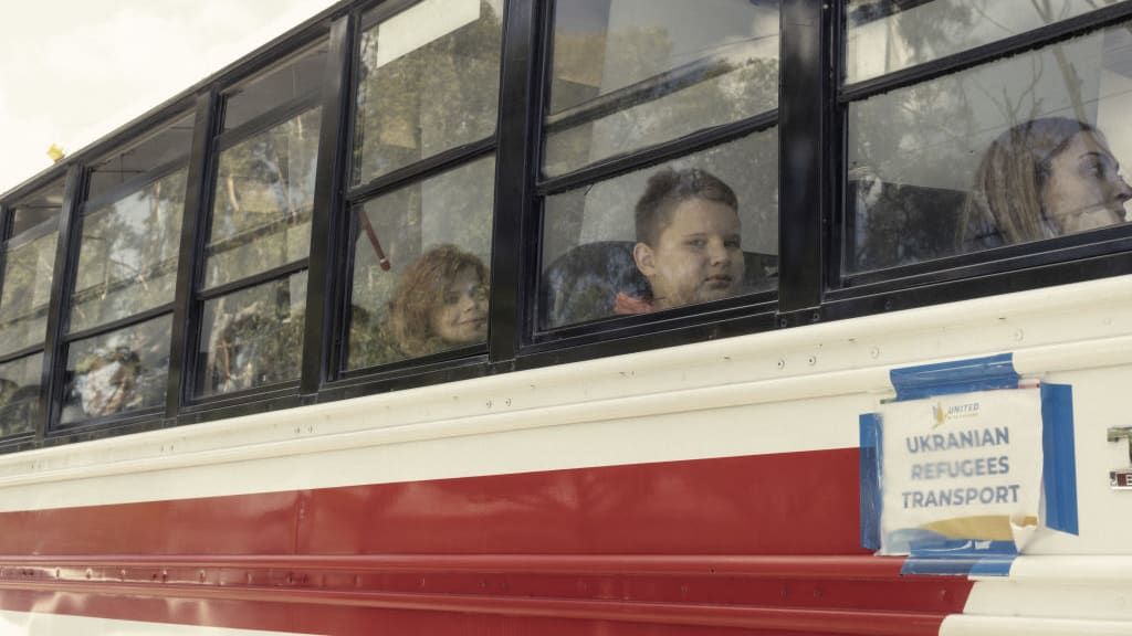 Ukrainian refugees on a bus traveling from Mexico to the United States.