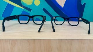 Photo of the Meta Ray-Ban Display (left) and Ray-Ban Meta (Gen 2, right) from the back showing their relative designs.