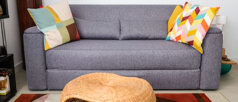 Emma Sofa Bed with waist pillows and colourful cushions