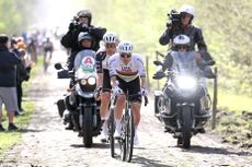 UAE Emirates-XRG's Slovenian rider Tadej Pogacar rides with his team over the cobblestones of the "trench" of Arenberg in Wallers, northern France, on April 9, 2026