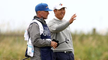 Byeong Hun An in discussion with caddie Justin York at The Open