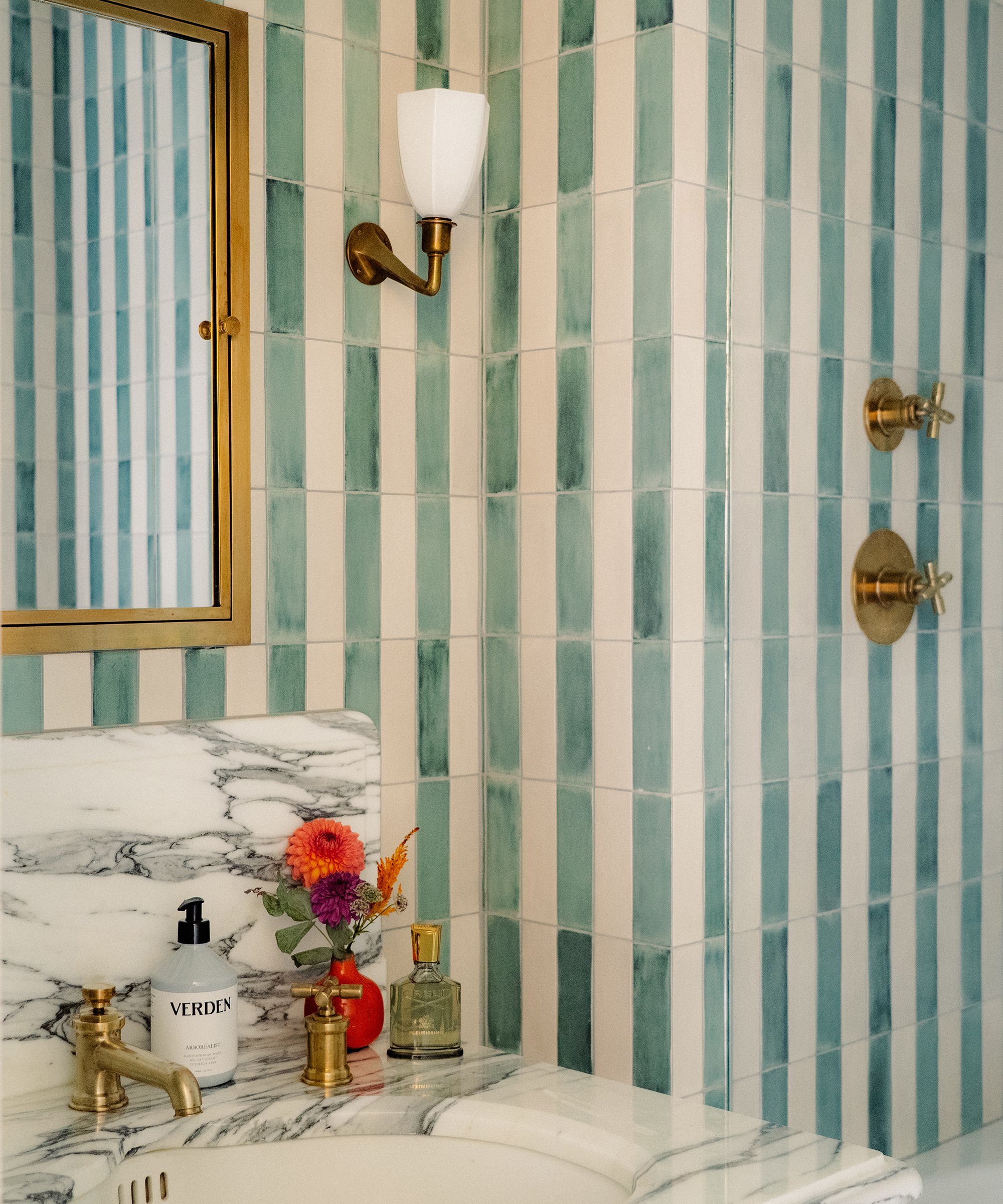 bathroom with striped green and white tiles on the wall