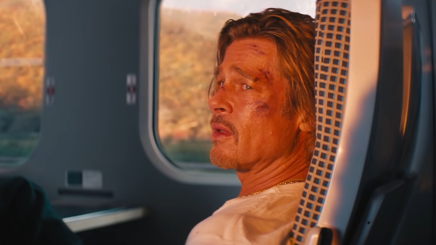 Brad Pitt sitting on a train in Bullet Train
