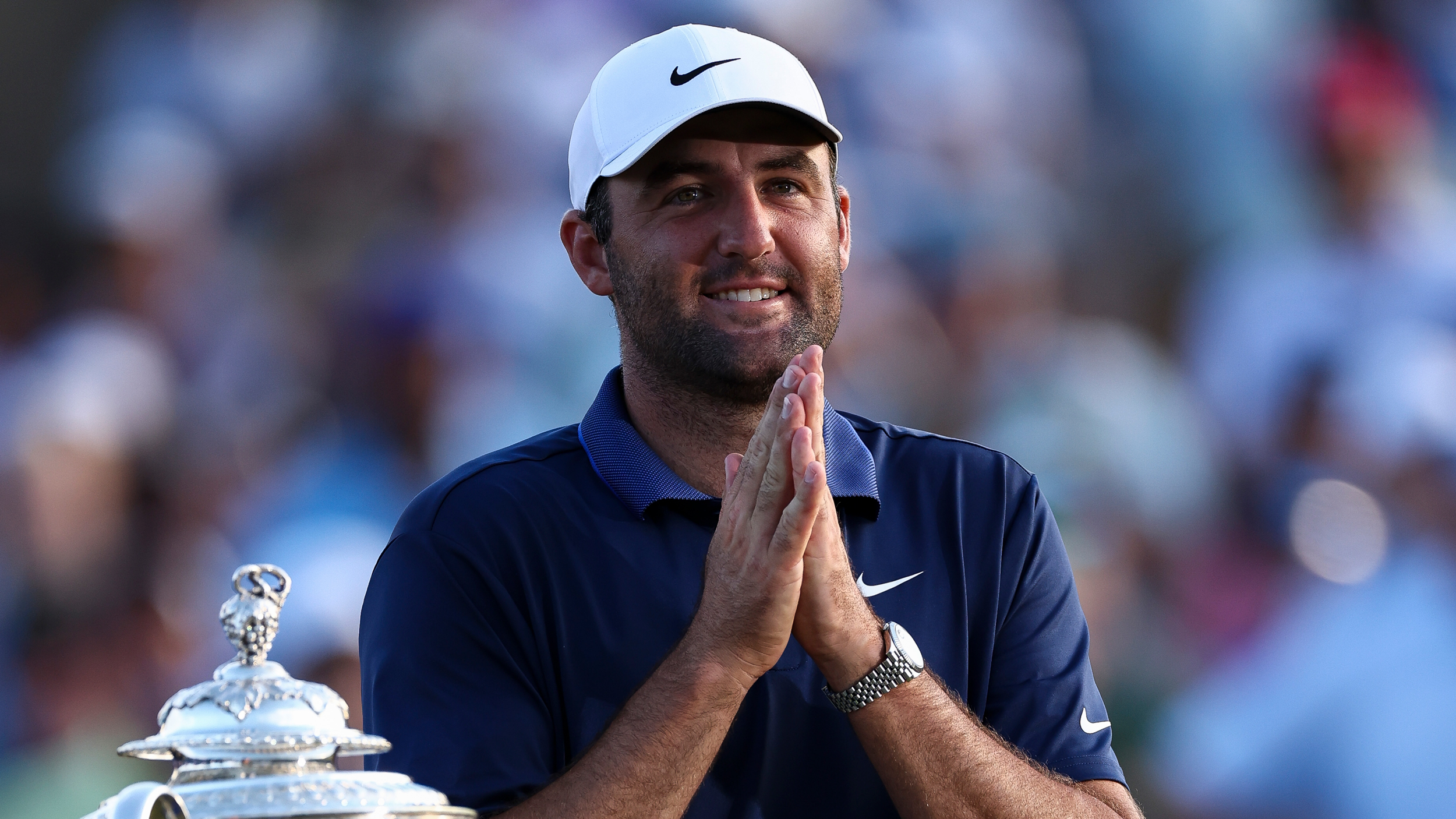 Scottie Scheffler smiles while placing his palms together after winning the 2025 PGA Championship