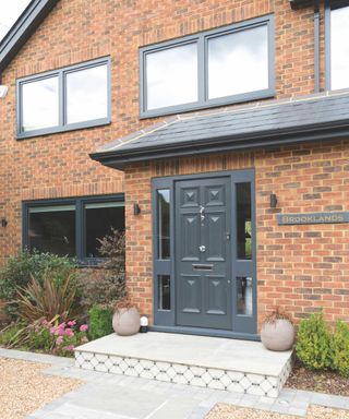 front extension to semi-detached house with grey windows and door