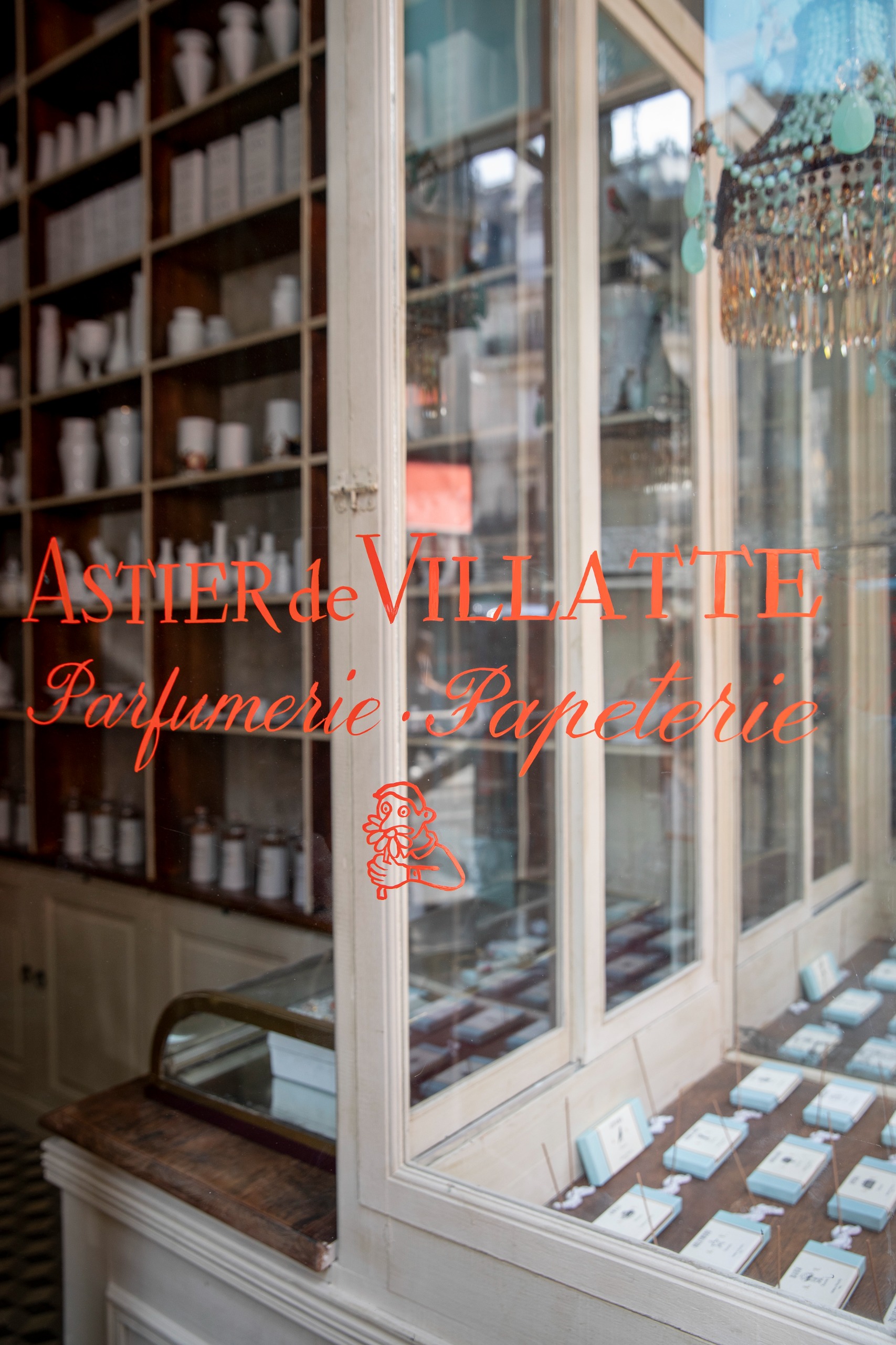 Interiors of an Art Deco-inspired parfumerie and stationery shops, with stacked-up wooden shelving, an earthy palette, and a stuck-in-time atmosphere with bespoke packaging.