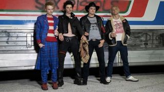 Cast of Pistol in costume, outside their tour bus