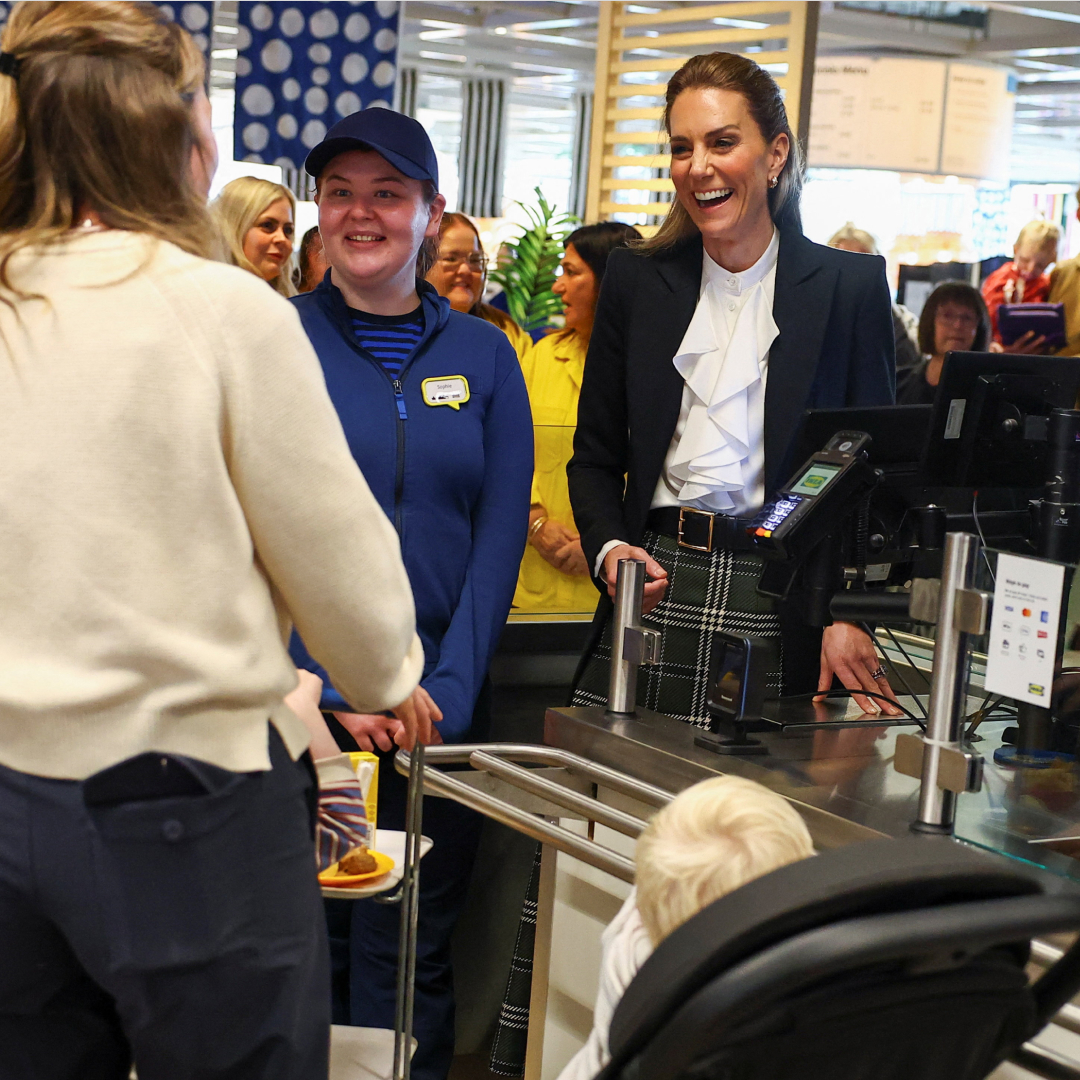 Princess Kate standing behind a cash register at IKEA serving a customer