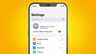 An iPhone on a yellow background showing how to cancel a subscription