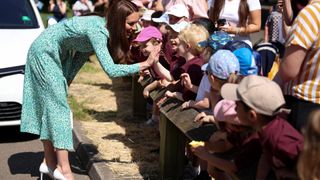 Catherine, Princess of Wales greets children as she visits field study health visitors at Riversley Park Children's Centre on June 15, 2023 in Nuneaton, England.