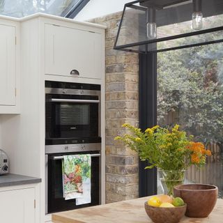 kitchen room with kitchen cabinet glass vase and oven