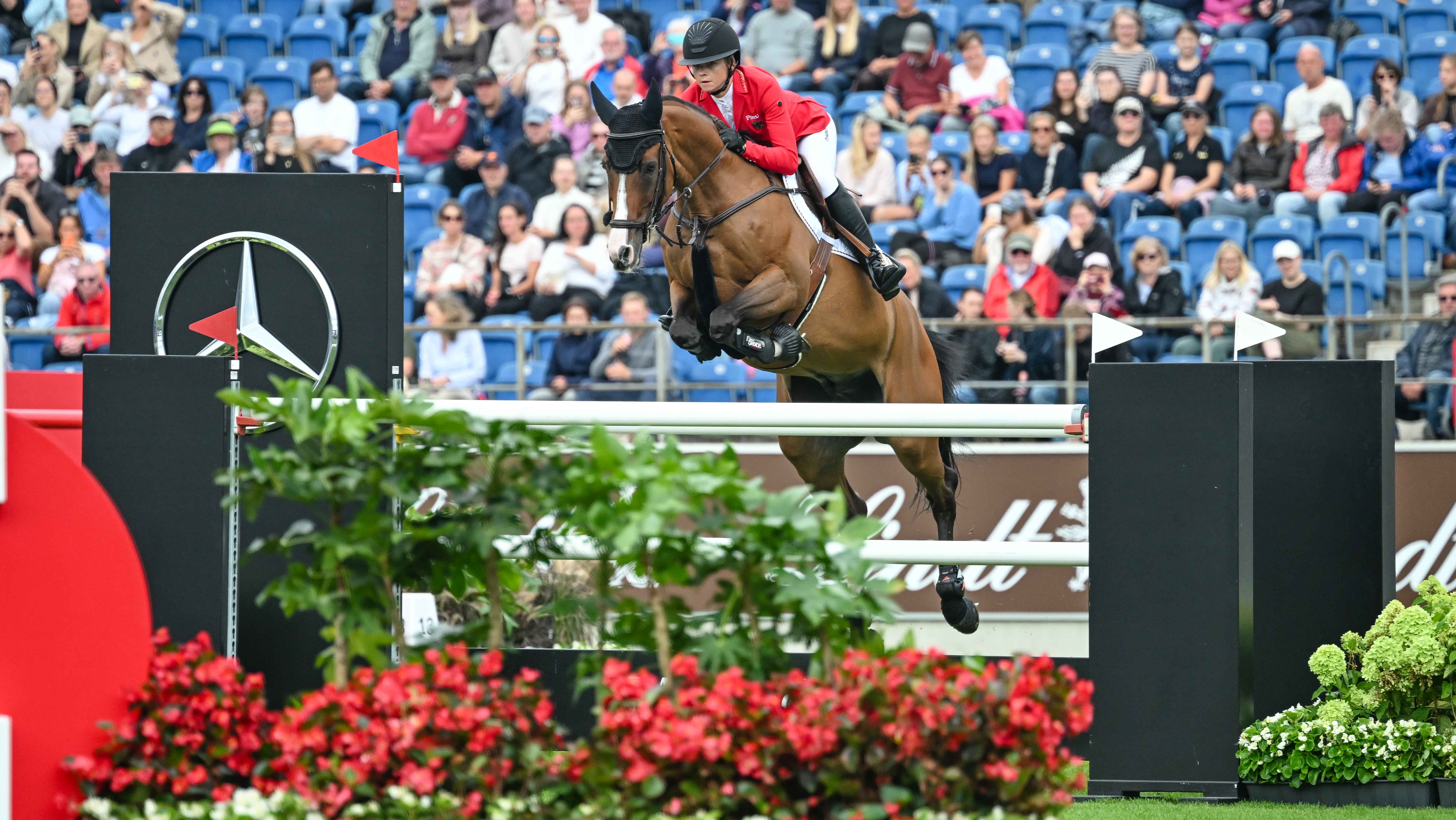 Sophie Hinners and Iron Dames Singclair jump a spread fence made of white poles en route to finishing fourth in the World Championships speed leg results