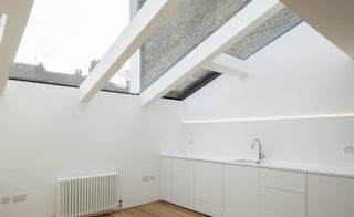 White kitchen area with glass roof