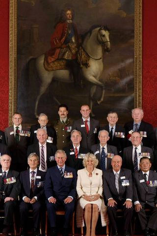 King Charles and Queen Camilla with military figures at St James's Palace