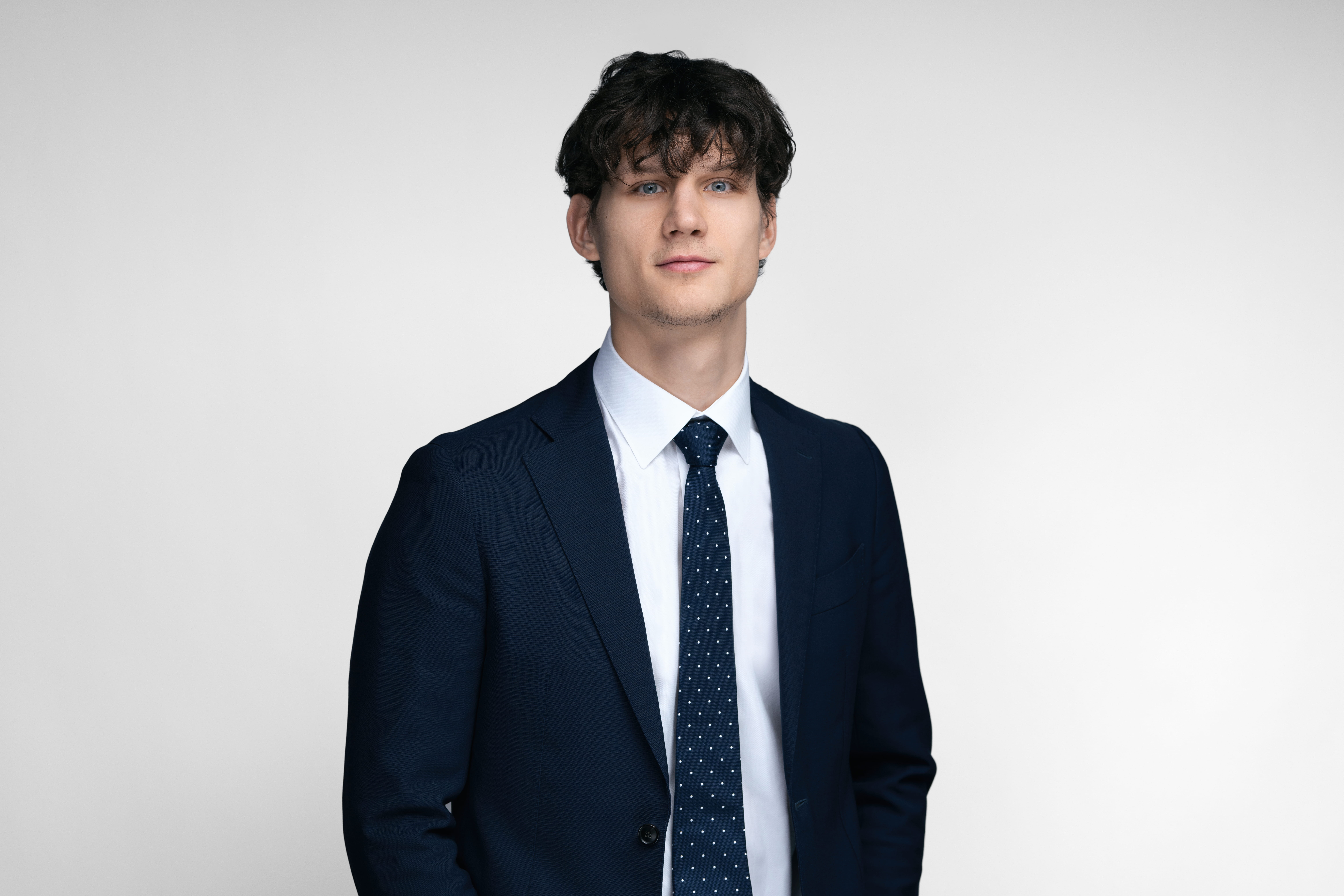 A man with a dark blue blazer.