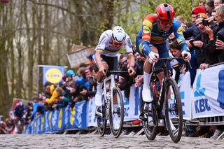WEVELGEM BELGIUM MARCH 24 LR Mathieu van der Poel of The Netherlands and Team Alpecin Deceuninck and race winner Mads Pedersen of Denmark and Team Lidl Trek compete passing through the Kemmelberg Belvedre cobblestones sector while fans cheer during the 86th GentWevelgem in Flanders Fields 2024 Mens Elite a 2531km one day race from Ieper to Wevelgem UCIWT on March 24 2024 in Wevelgem Belgium Photo by Tim de WaeleGetty Images