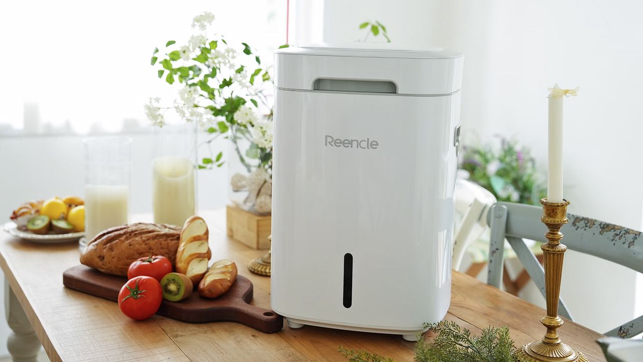 Reencle Home Composter on tabletop next to food