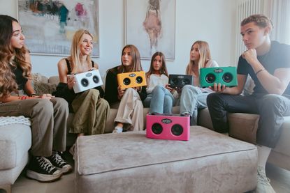 A group of friends listening to music on the BoomBocs STUDIO smart speaker