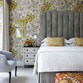bedroom with printed wall and bed with pillows