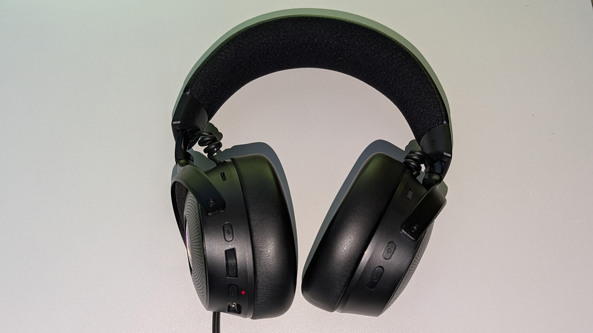 Razer Kraken V4 Pro gaming headset on a desk and with RGB enabled.