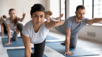 Yoga class engaging their core 