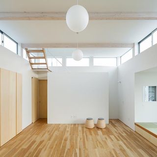 Floating House with wooden flooring and white walls