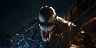 Venom smiles at the camera, jaws wide open