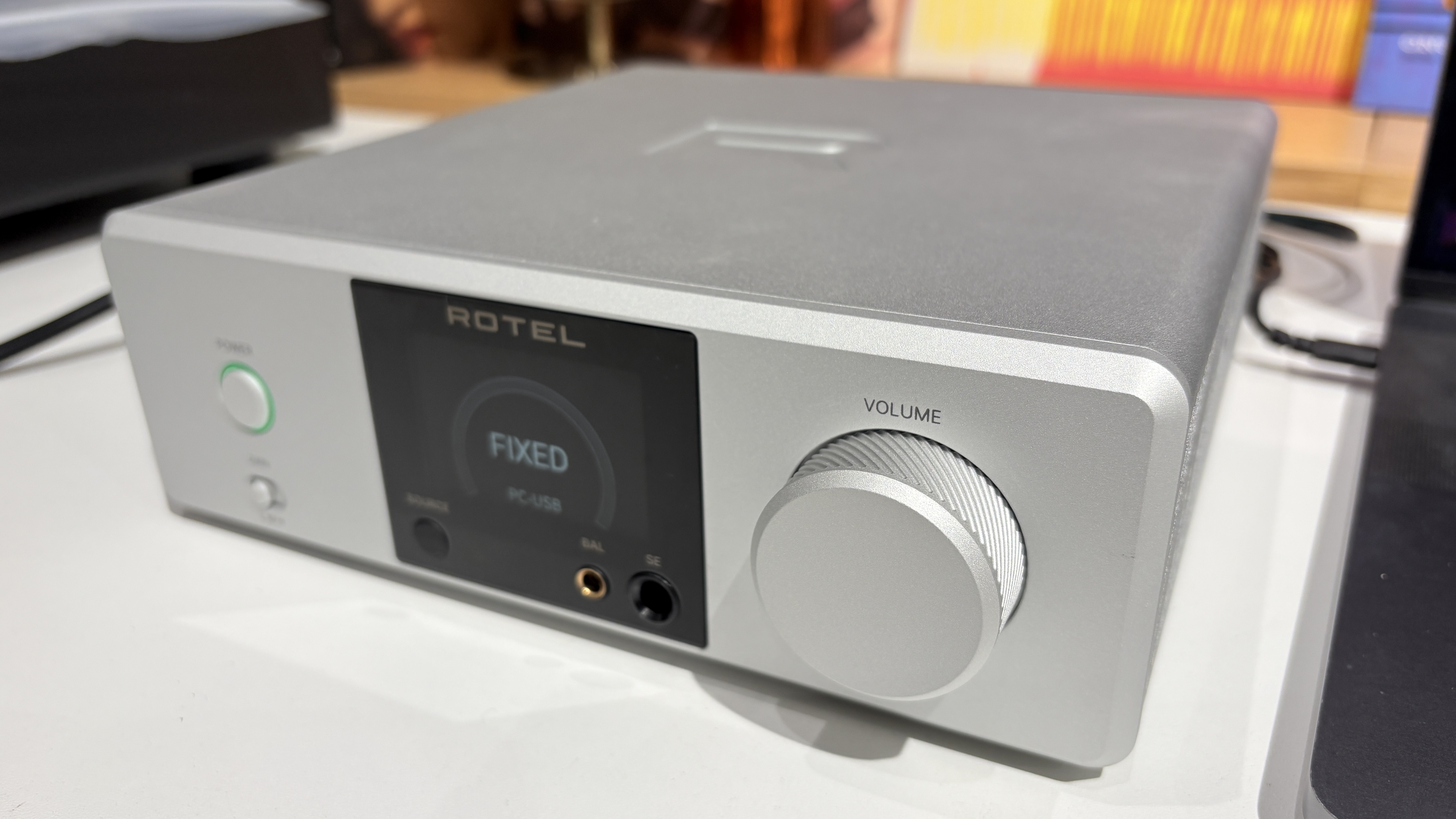 Rotel DX-3 on white desk next to MacBook laptop