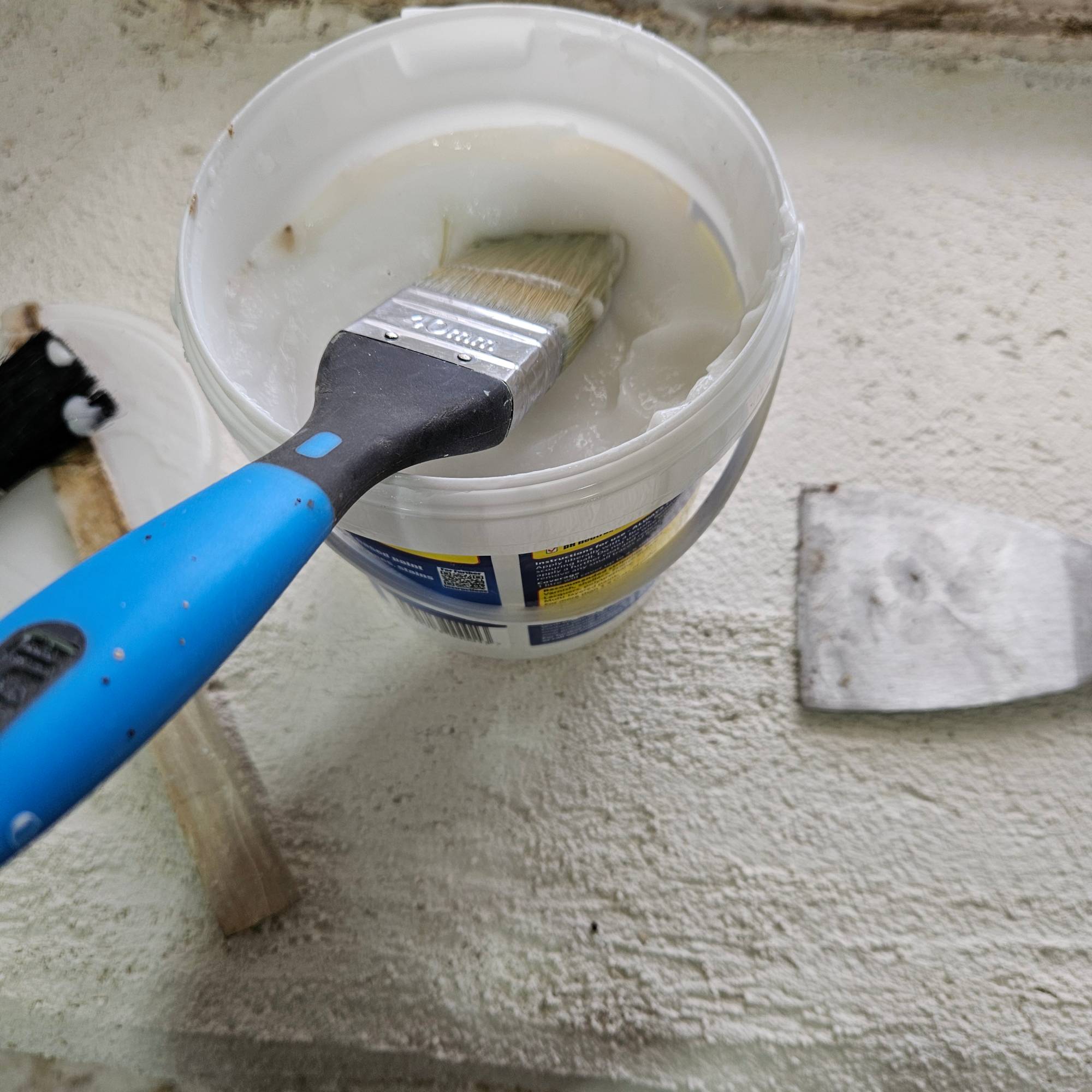 blue paint brush in paint stripper gel