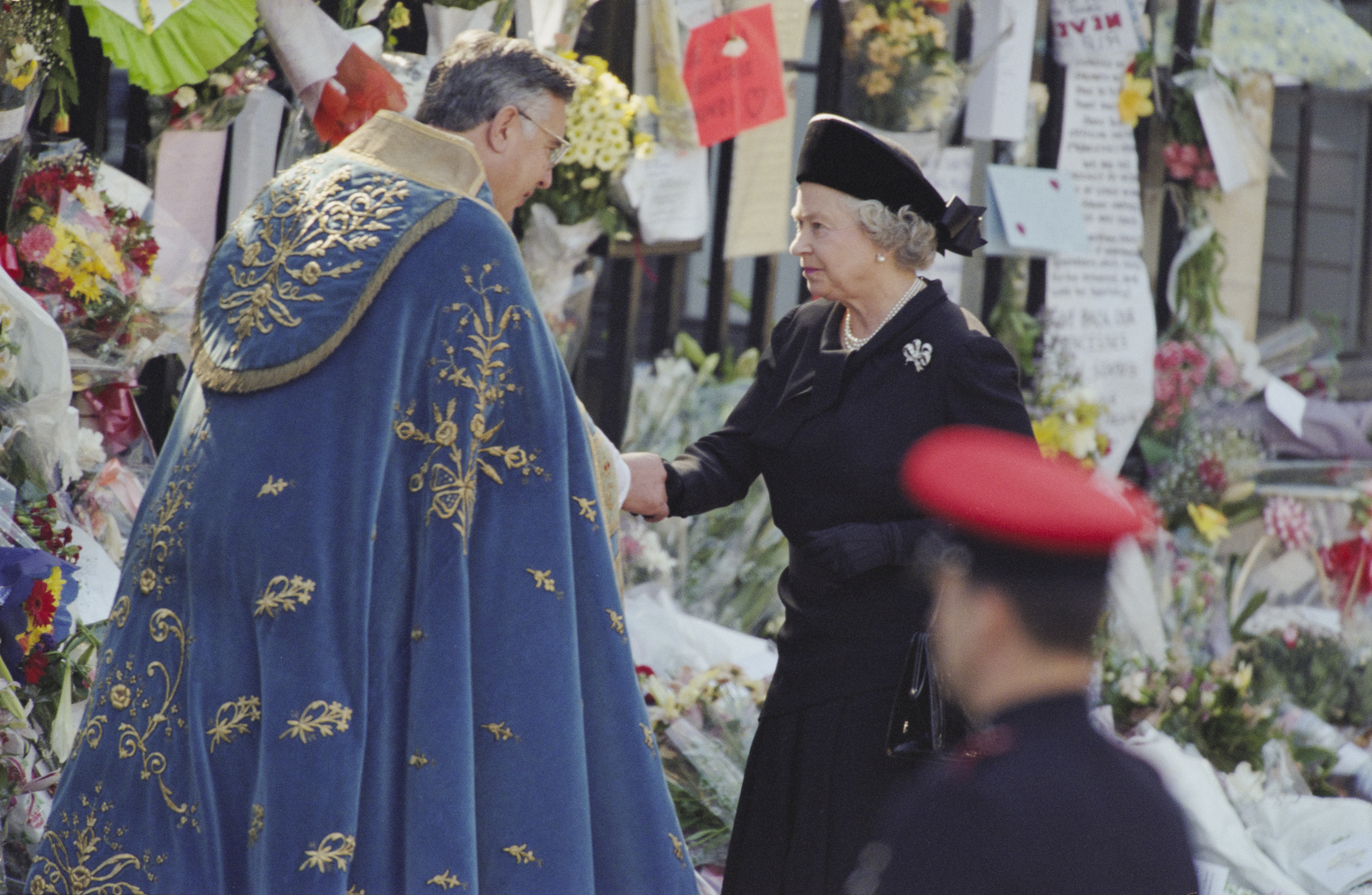 Queen Elizabeth shaking hands at the funeral of Princess Diana