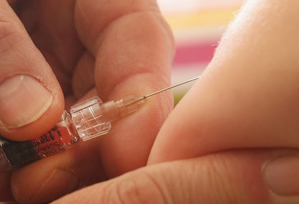 A baby receives a vaccination.