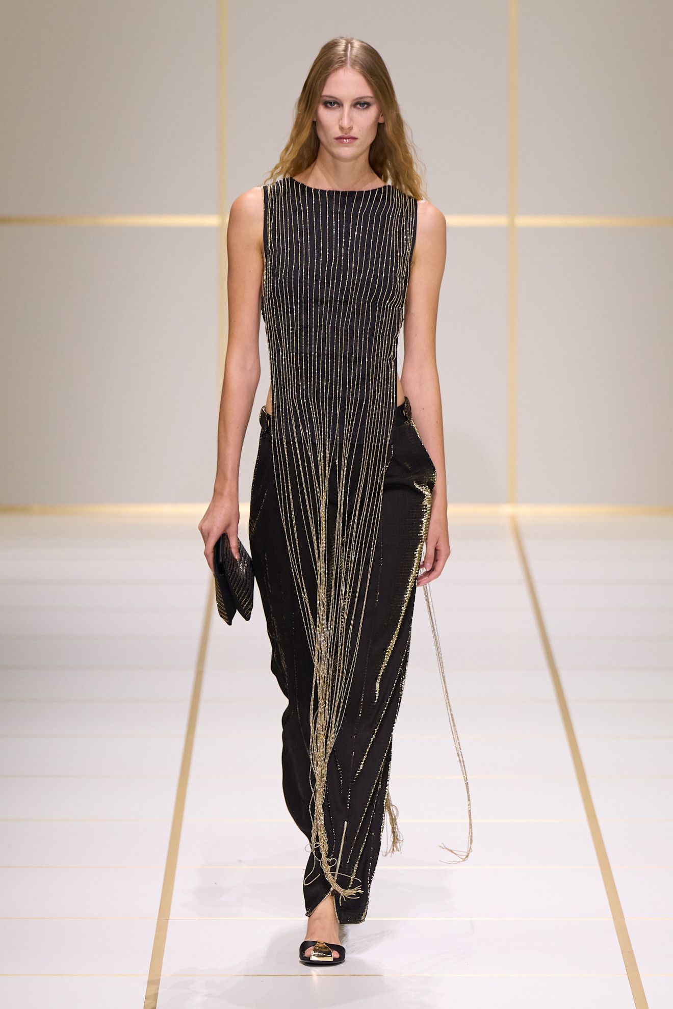a model walks the giorgio armani s/s 27 runway.