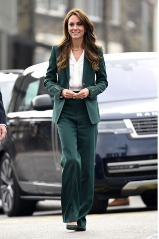Catherine, Princess of Wales wears a green pantsuit and matching heels as she visits AW Hainsworth on September 26, 2023 in Leeds, England. The Princess of Wales is visiting Leeds and Lancaster to learn more about the textile industry's heritage, sustainable practices and work educating and upskilling young people.