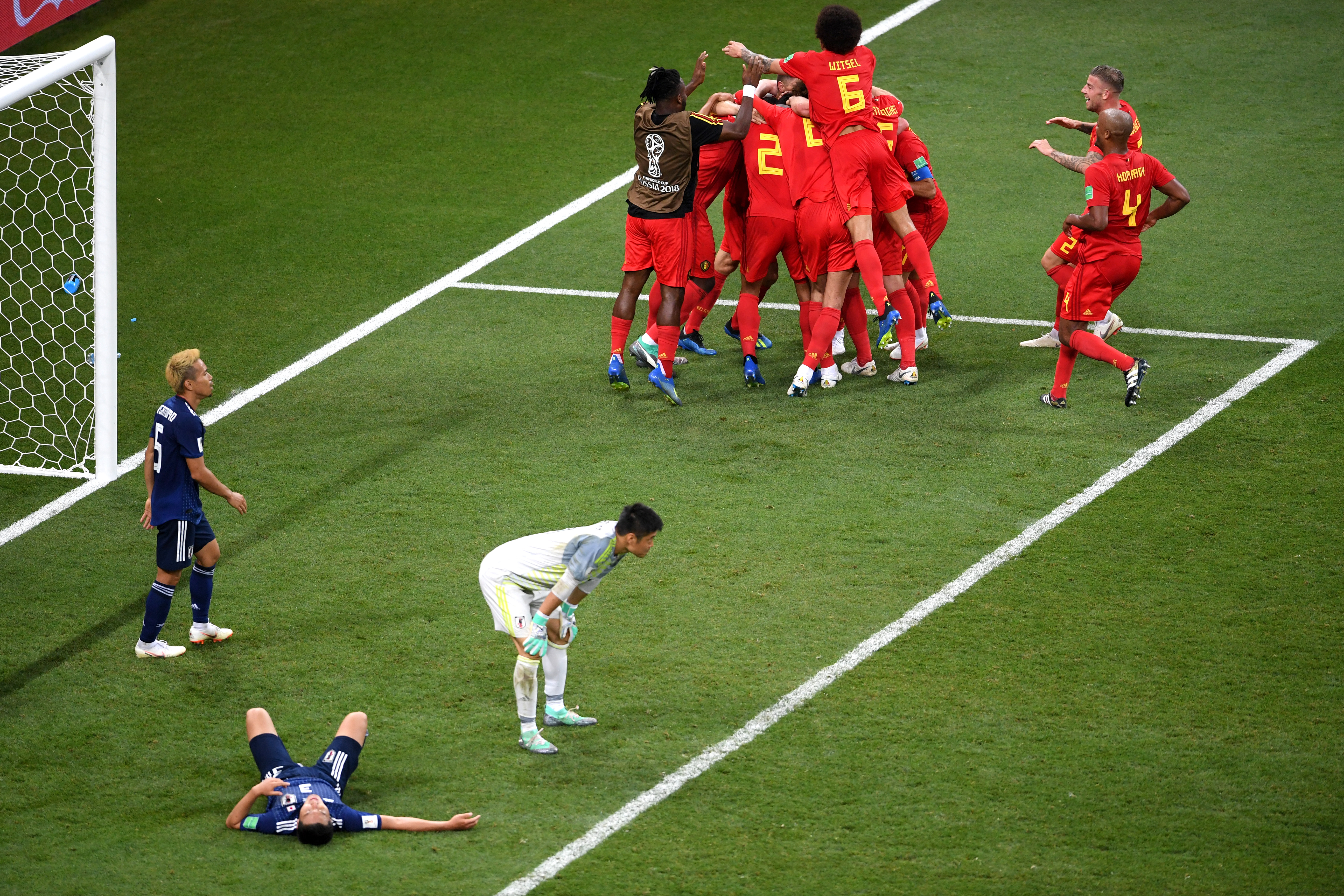 Japan players are crestfallen as Belgium celebrate Nacer Chadli's goal in added time which sealed a 3-2 win for the European side in the last 16 of the 2018 World Cup.