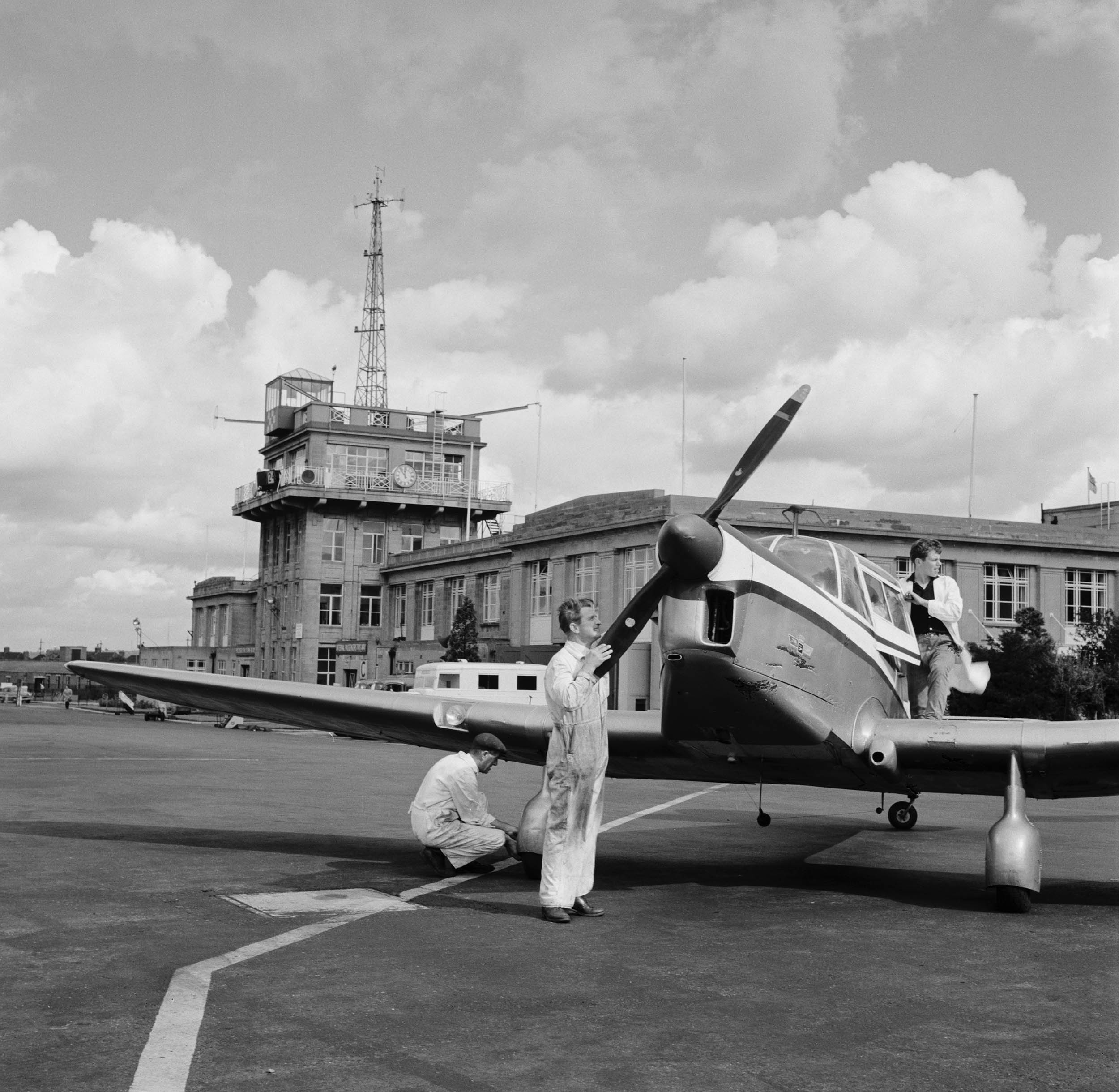 Mechanics working on a small aircraft at Croydon Airport in Surrey, September 26th 1958.  