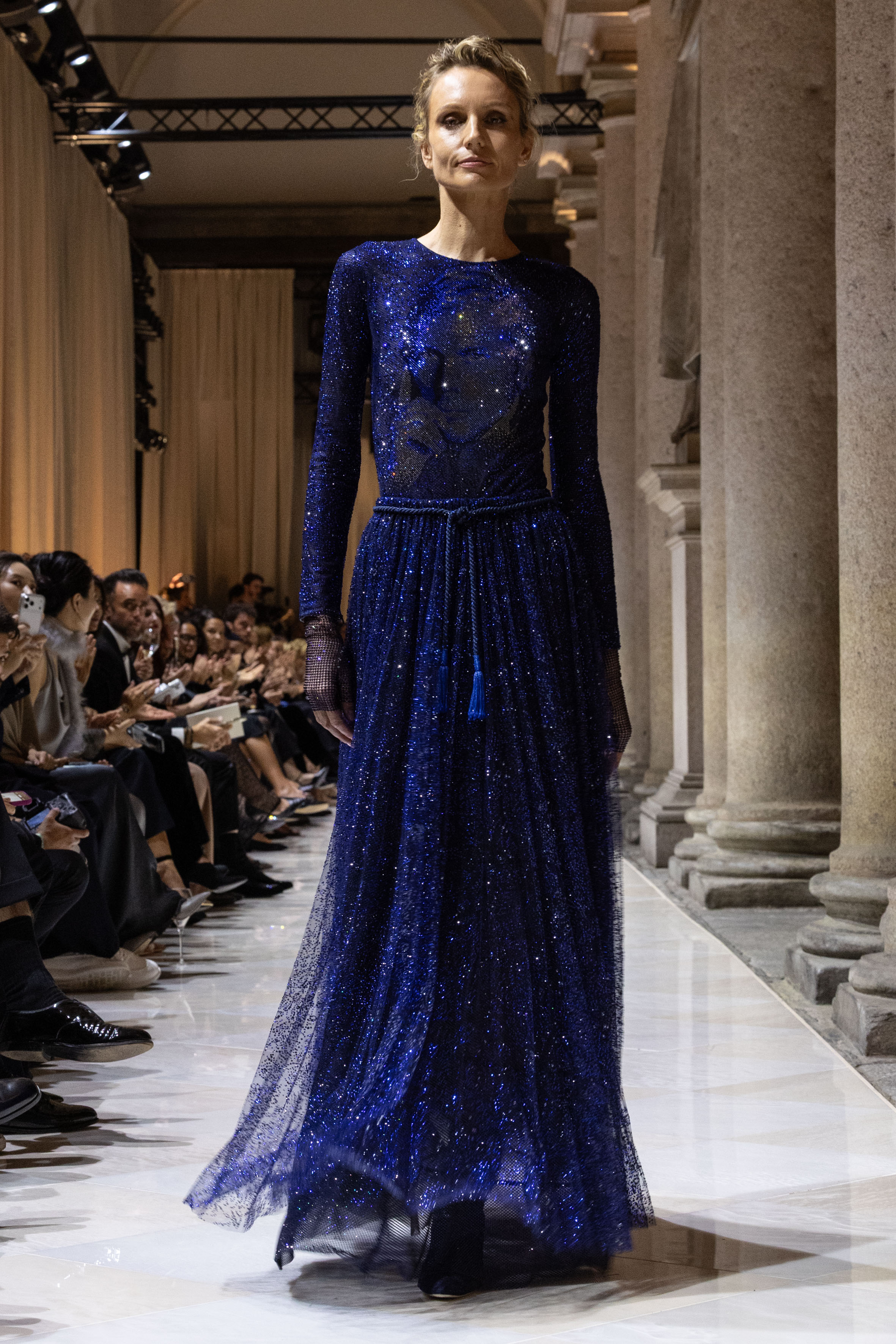 a model wears a dress with giorgio armani&#039;s face for the ss26 show