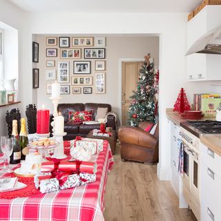 dining table decked with checked tablecloth and Christmas crackers and decorations
