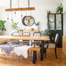 dining room with wooden dining table and bench with black chairs