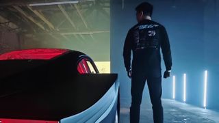 Photo of man standing next to a Porsche