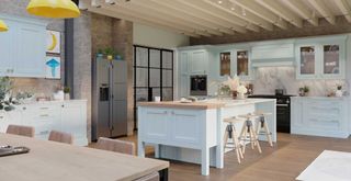 sky blue kitchen with large kitchen island and yellow pendant lights