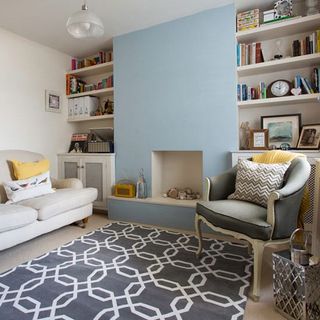 living room with rug on floor and white shelves