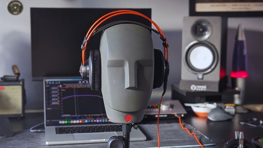 A pair of AKG K712 Pro studio headphones on a Neumann KU 100 dummy head