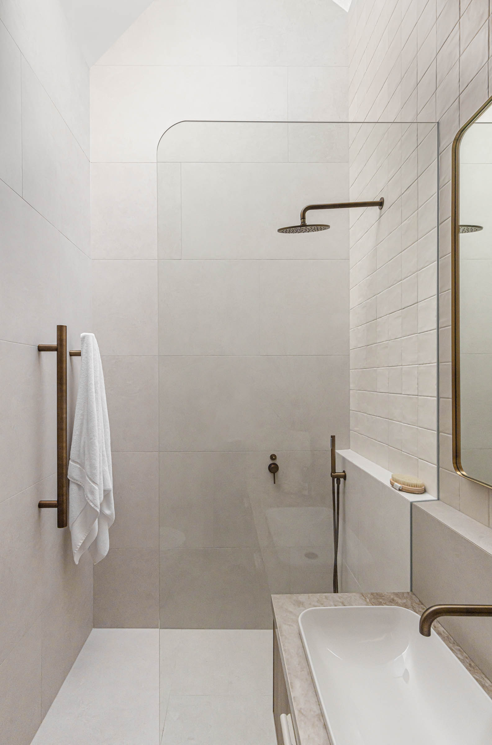 Bathroom with shower head and gray beige tiles