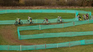 CX racers on a hillside track
