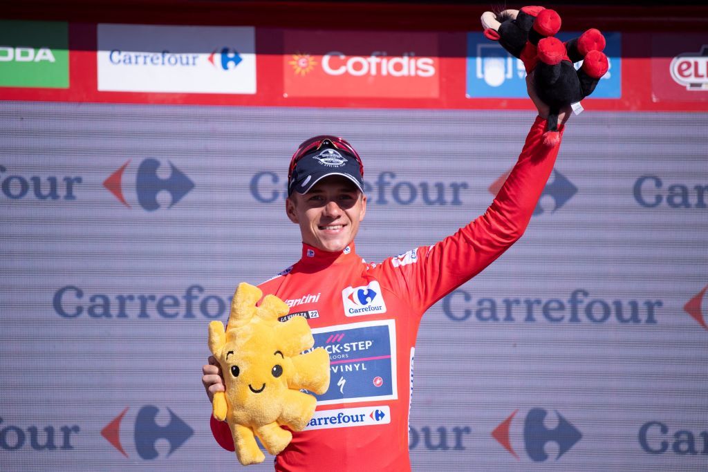 Team Quick Steps Belgian rider Remco Evenepoel celebrates on the podium wearing the overall leaders red jersey after the 15th stage of the 2022 La Vuelta cycling tour of Spain a 153 km race from Martos to the Alto Hoya de la Mora of the Sierra Nevada in Monachil on September 4 2022 Photo by JORGE GUERRERO AFP Photo by JORGE GUERREROAFP via Getty Images