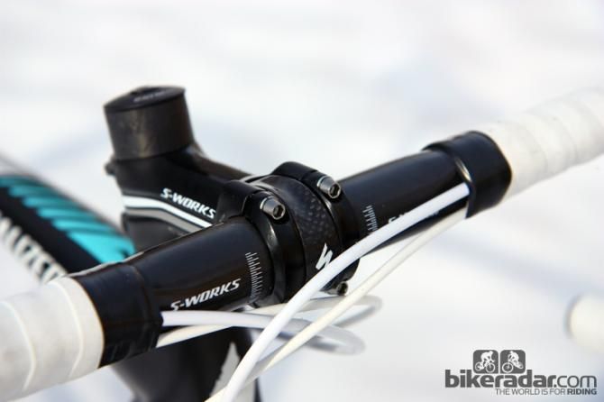 The little carbon fiber clip holds the faceplate in place even when the bolts are removed - so you have one fewer thing to hold on to if you're swapping a stem.