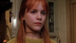 Evan Rachel Wood looking out the window in Practical Magic. 
